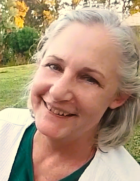 Di, founder of SpeakWithDi, smiling outdoors